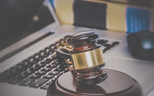 A gavel sitting on a keyboard